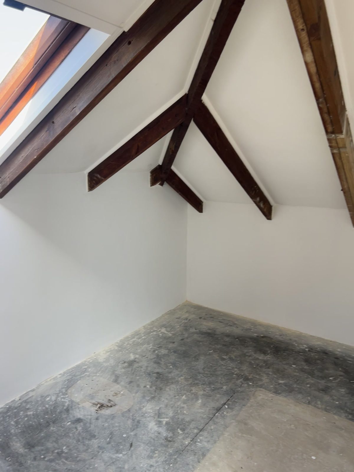 Feather-finish screed being laid over the sealed bitumen in the Mowbray attic