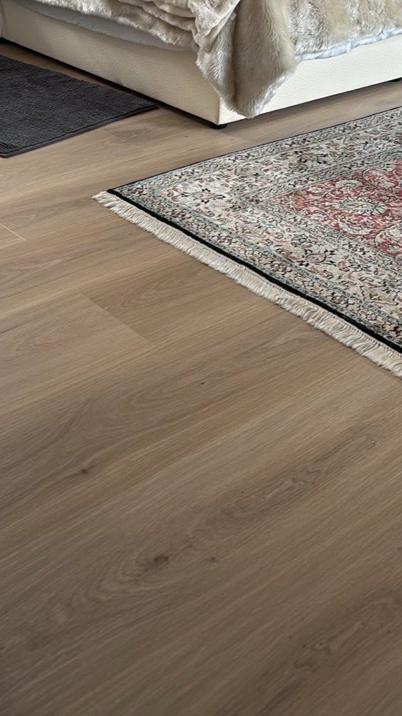 Warm Italian Oak SPC floor softened with a rug in the Sunset Beach home